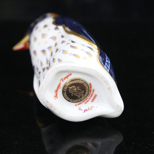 775 - A Royal Crown Derby Rockhopper penguin paperweight, with gold button