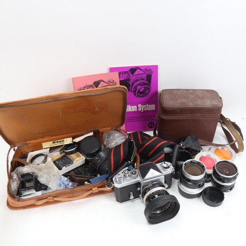 1040 - A Vintage Nikon F 35mm single lens reflex camera, and 2 cases of Nikon accessories and lenses