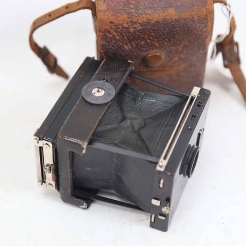 1042 - A Vintage Stereoscopic Co Vesca folding strut camera, with green leather cover and Negretti & Zambra... 