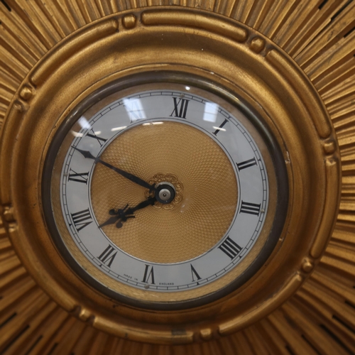 1073 - A Vintage gilt sunburst wall clock, width 50cm