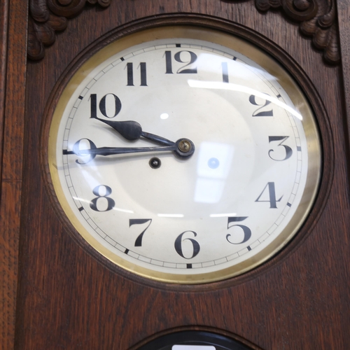 1074 - A Continental oak-cased wall clock, with 2-train movement, height 71cm