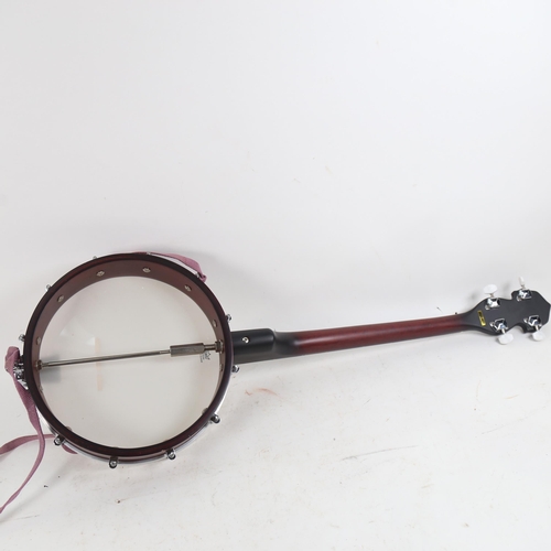 1098 - An Ozark banjo, with carrying case and instruction books