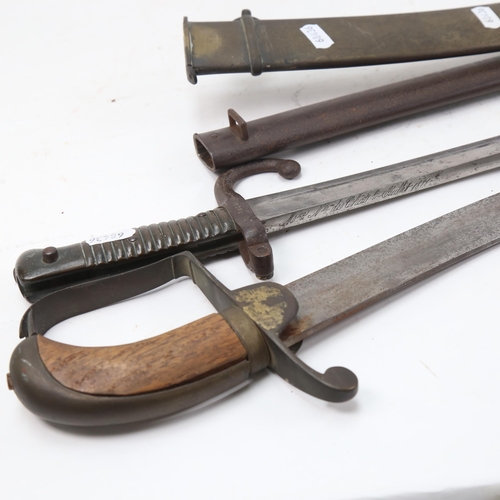 904 - A French 1871 pattern sword bayonet and scabbard, and a Middle Eastern tulwar sword and scabbard (2)