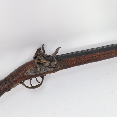 913 - A reproduction double-barrelled flintlock sporting gun, barrel length 74cm