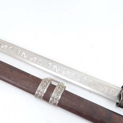 915 - A reproduction Eastern sword and hardwood scabbard, blade length 71cm