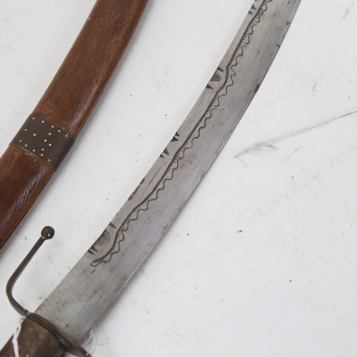 919 - A Middle Eastern/Persian curved sword, with chip carved wood handle and scabbard, blade length 39cm