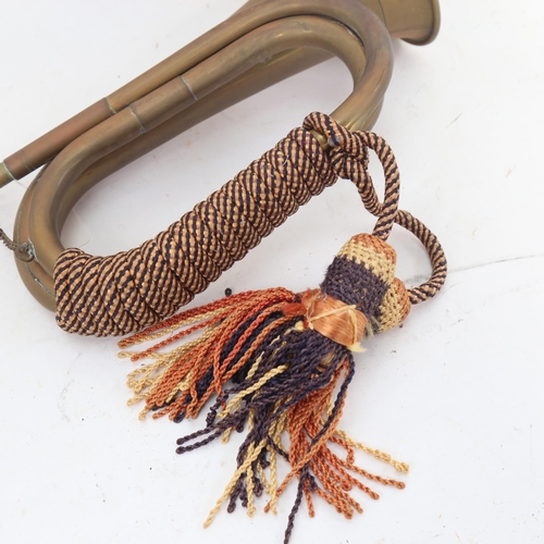 925 - A First World War Period brass bugle, with rope tassels