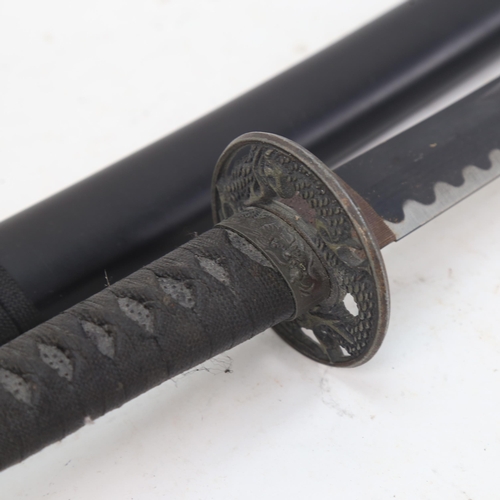 951 - A replica Japanese katana sword and scabbard, with blackened steel blade, blade length 70cm