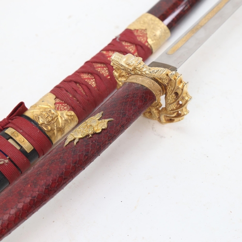 953 - A replica Japanese katana sword and scabbard, with scabbard knife and snakeskin grip, 70cm