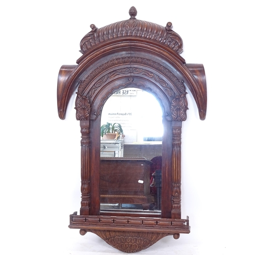 2411 - An ornate hardwood arch-top wall mirror, with allover carved decoration, W77cm, H130cm