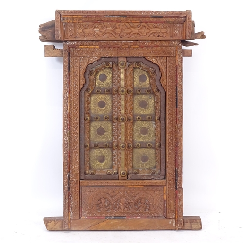 2413 - An ornate Indian hardwood and brass decorated window, with allover relief carved decoration, W60cm, ... 