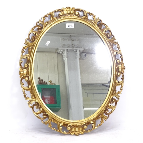 2416 - An oval wall mirror, in a pierced and carved acanthus leaf design gilt frame, W53cm, H63cm