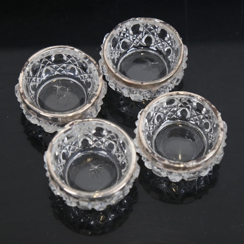 1263 - A cased set of 4 glass and silver-mounted salts