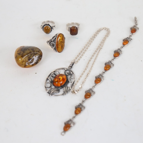 1294 - A tray containing 3 silver and amber mounted rings, an amber and silver bracelet, pendant etc