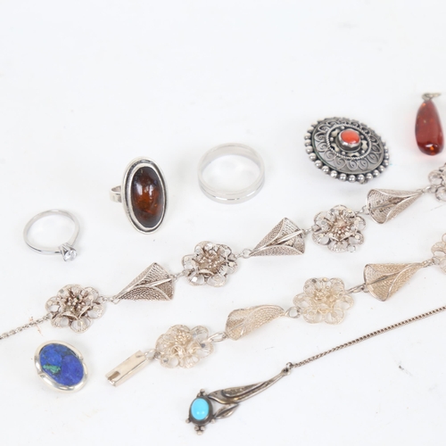 1297 - A tray containing Danish silver jewellery, a silver and amber set ring, a target brooch, a silver fi... 