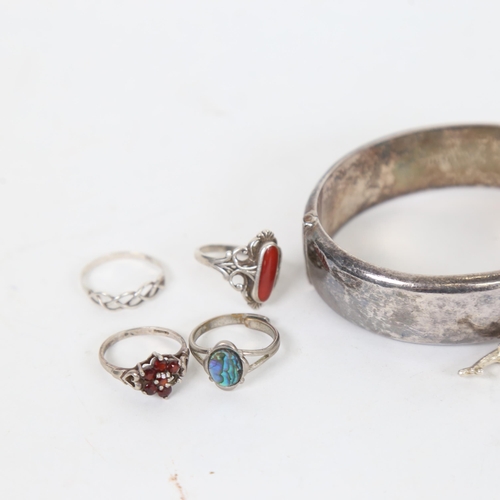 1305 - A group of silver jewellery, to include an engraved hinged bangle, 4 stone set rings, buckle ring et... 