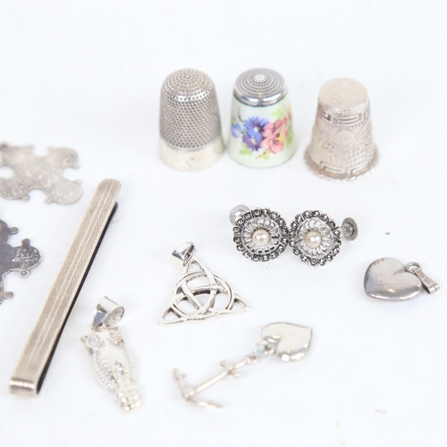 1313 - A floral enamelled thimble, 2 other silver thimbles, a tie pin, pendants etc