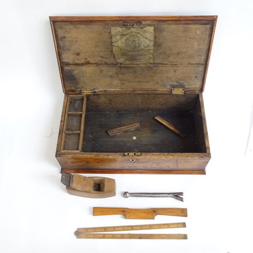 998 - A tool box with brass handles containing a number of woodworking tools.