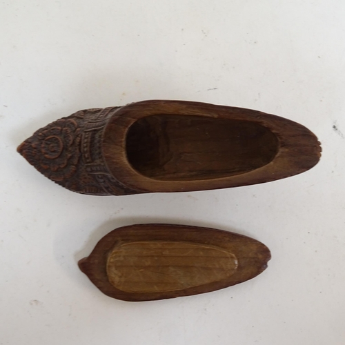 808 - A treen lady's shoe snuffbox, a carved wooden clog, and Grindelwald travelling pocket watch case (3)