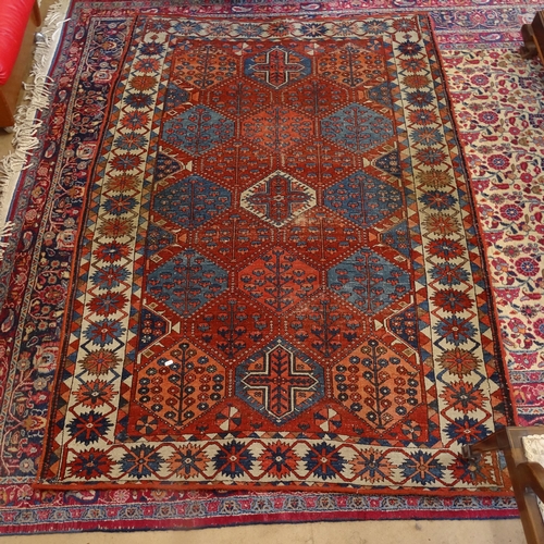 2405 - An Antique red ground Caucasian rug, 200cm x 146cm