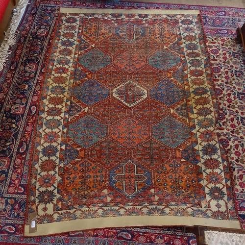 2405 - An Antique red ground Caucasian rug, 200cm x 146cm