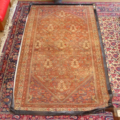 2406 - A red ground Persian Heriz rug, 207cm x 138cm