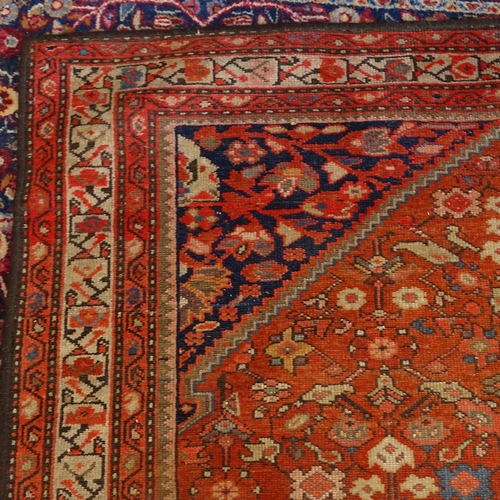 2406 - A red ground Persian Heriz rug, 207cm x 138cm