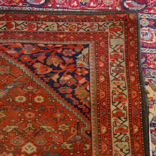 2406 - A red ground Persian Heriz rug, 207cm x 138cm