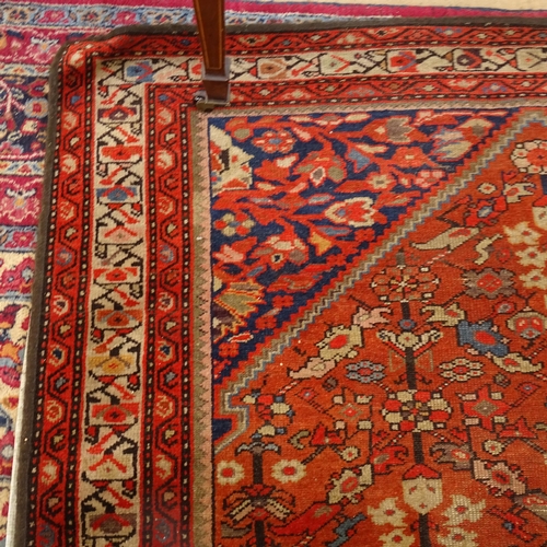 2406 - A red ground Persian Heriz rug, 207cm x 138cm