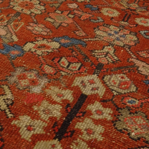 2406 - A red ground Persian Heriz rug, 207cm x 138cm