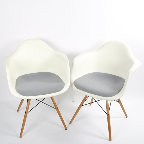 1565 - CHARLES EAMES for Vitra, a pair of DAW armchairs, with white shell and grey padded seat, on maple an... 