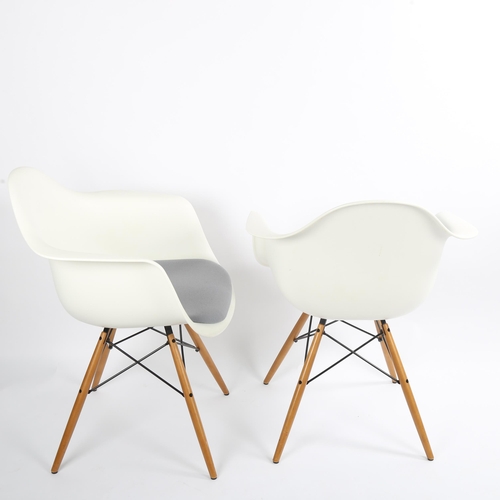 1565 - CHARLES EAMES for Vitra, a pair of DAW armchairs, with white shell and grey padded seat, on maple an... 