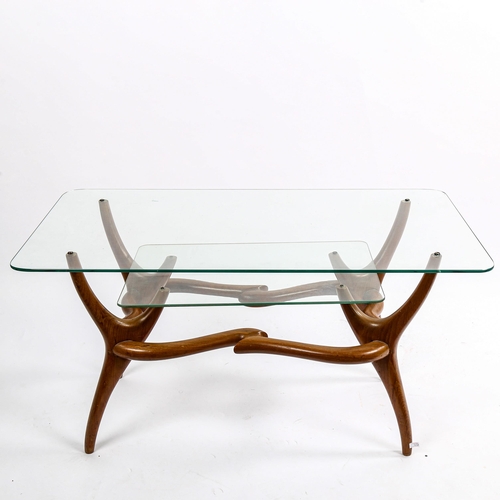 1567 - A mid-century Italian 2-tier glass coffee table, with organic sculptural base in walnut, in the mann... 