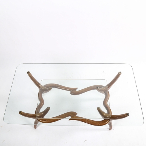 1567 - A mid-century Italian 2-tier glass coffee table, with organic sculptural base in walnut, in the mann... 