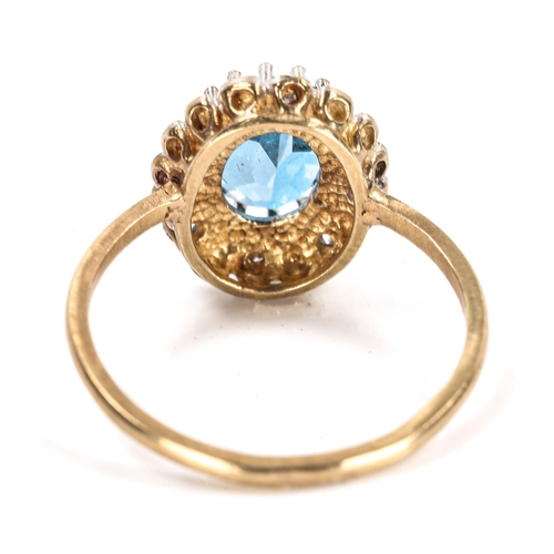 106 - A modern blue topaz and diamond cluster ring, unmarked gold settings with oval mixed-cut topaz and s... 