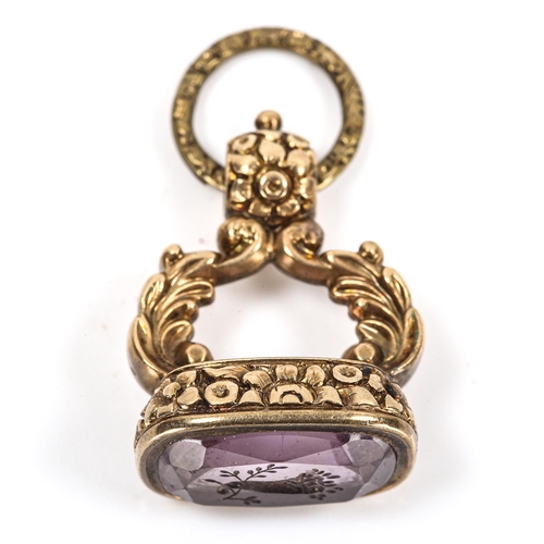 111 - A 19th century amethyst seal fob, unmarked yellow metal chased floral settings with cornucopia desig... 