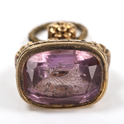 111 - A 19th century amethyst seal fob, unmarked yellow metal chased floral settings with cornucopia desig... 