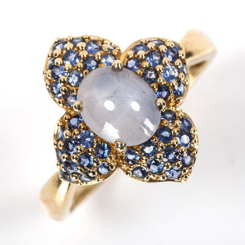 112 - A modern 9ct gold star sapphire flowerhead cluster ring, set with oval cabochon star sapphire and pa... 