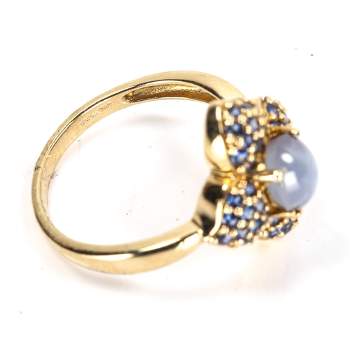 112 - A modern 9ct gold star sapphire flowerhead cluster ring, set with oval cabochon star sapphire and pa... 