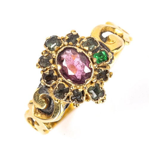 122 - A Victorian ruby and emerald cluster dress ring, pierced foliate shoulders with engraved shank, 12mm... 