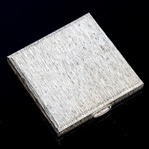 126 - An Elizabeth II square silver compact, allover bark effect design, by Kigu Ltd, hallmarks London 197... 