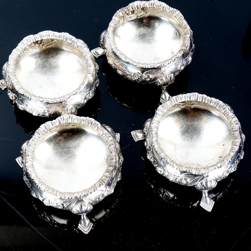 130 - A set of 4 Edwardian silver salt cellars, relief embossed floral decoration with blue glass liners, ... 