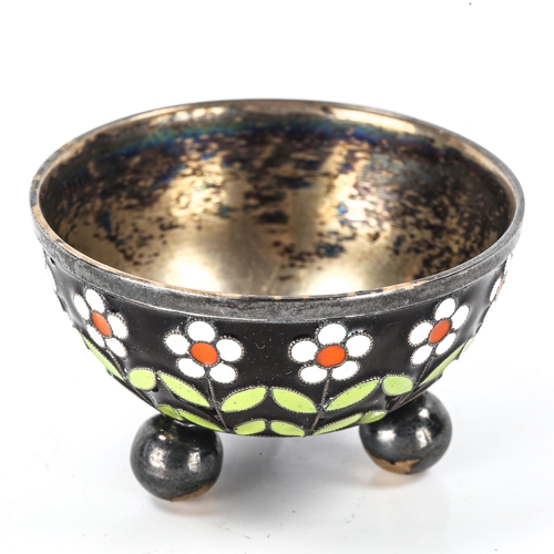 135 - A Russian silver and champleve enamel salt cellar, daisy flower decoration on 3 bun feet, marks on b... 