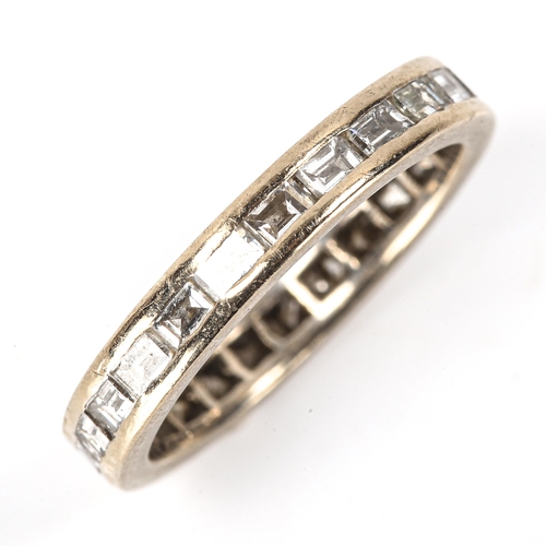 142 - A baguette-cut diamond eternity ring, unmarked white metal settings, band width 3.4mm, size L, 3.2g