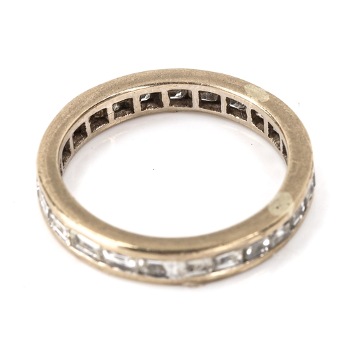 142 - A baguette-cut diamond eternity ring, unmarked white metal settings, band width 3.4mm, size L, 3.2g