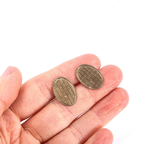 162 - A pair of early 20th century 9ct gold oval cufflinks, engine turned decoration, maker's marks LAP, h... 