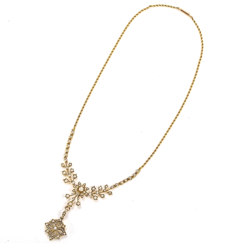 66 - An Edwardian 15ct gold pearl and diamond necklace, floral design set with split pearls and diamond s... 