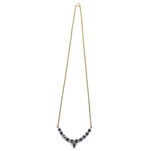 72 - A 9ct gold and silver blue and white sapphire necklace, on rope twist chain, necklace length 42cm, 1... 