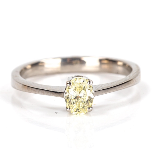 86 - A modern 18ct white gold 0.5ct fancy yellow solitaire diamond ring, plain 4-claw setting with oval b... 