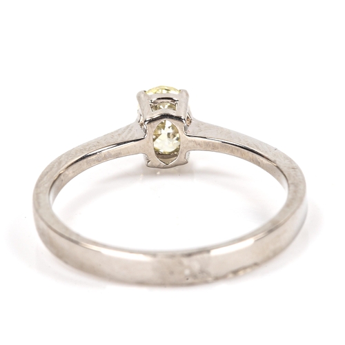 86 - A modern 18ct white gold 0.5ct fancy yellow solitaire diamond ring, plain 4-claw setting with oval b... 